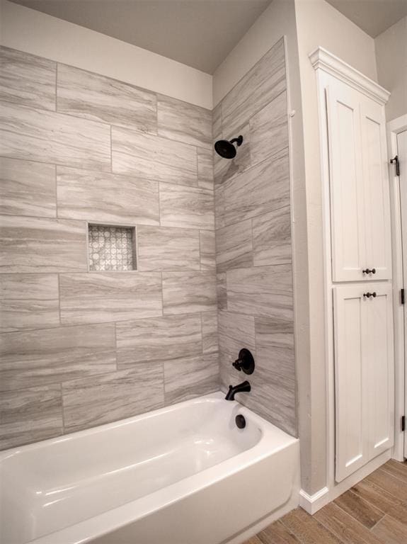 full bathroom featuring shower / bath combination and wood finished floors