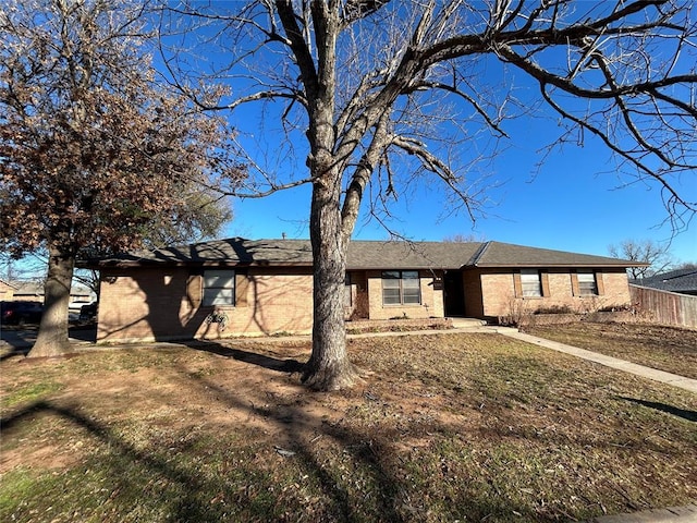 ranch-style home with a front lawn