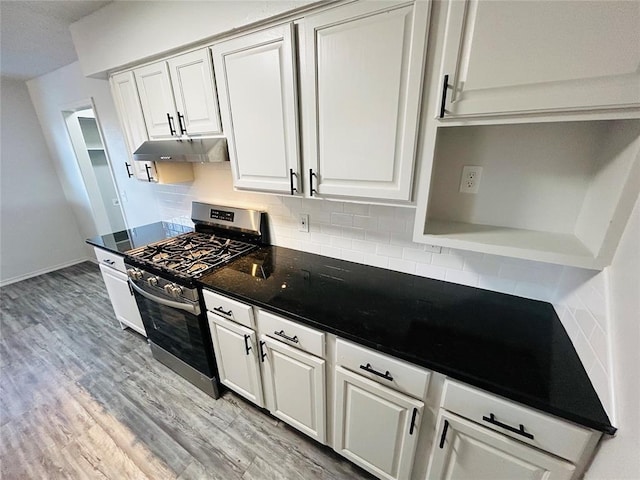 kitchen with backsplash, white cabinetry, light hardwood / wood-style flooring, and stainless steel range with gas stovetop