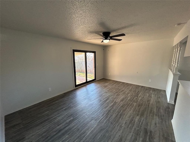 empty room featuring ceiling fan, dark hardwood / wood-style flooring, and a textured ceiling