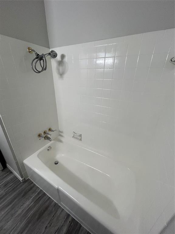 bathroom featuring hardwood / wood-style floors and tub / shower combination