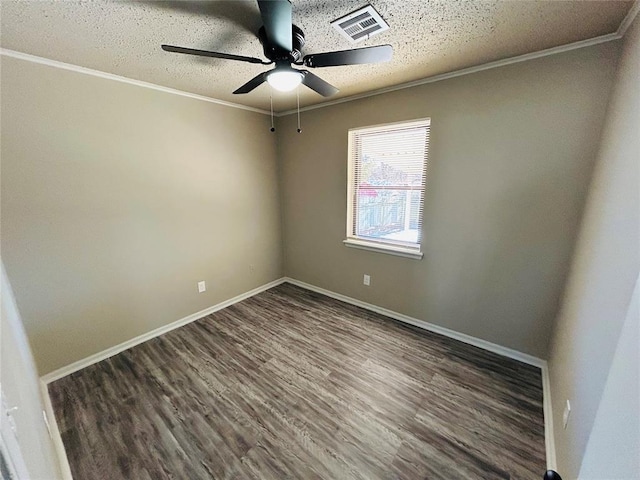 empty room featuring ceiling fan, dark hardwood / wood-style flooring, a textured ceiling, and ornamental molding