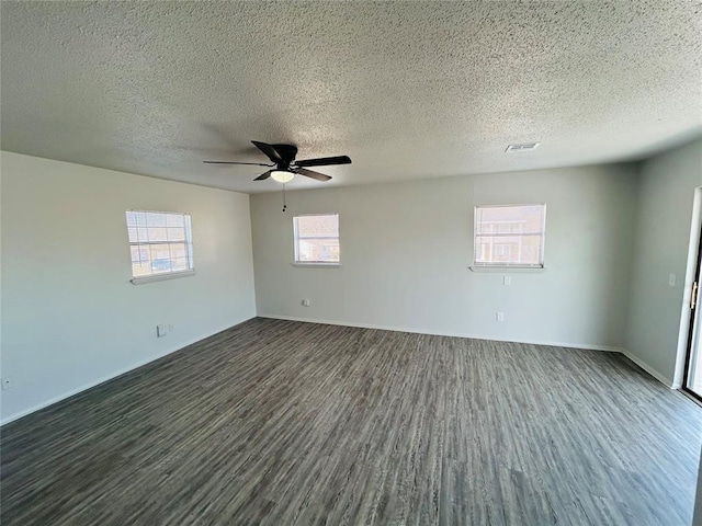 unfurnished room with a textured ceiling, dark hardwood / wood-style flooring, and ceiling fan