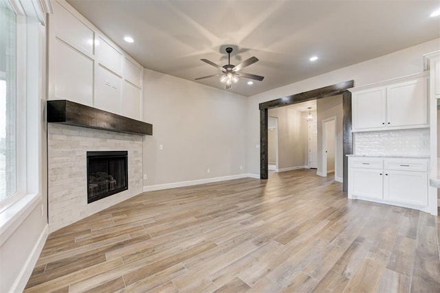 unfurnished living room featuring light wood-type flooring and ceiling fan