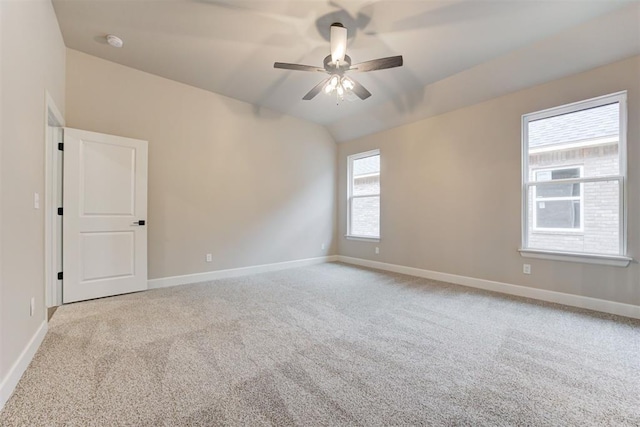 spare room with ceiling fan, light colored carpet, and lofted ceiling