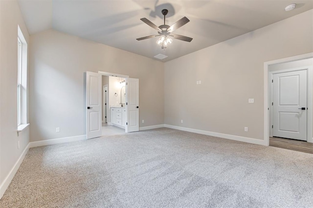 unfurnished room with ceiling fan, light colored carpet, and lofted ceiling