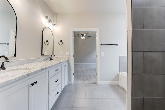 bathroom with tile patterned floors, ceiling fan, a tub to relax in, and vanity