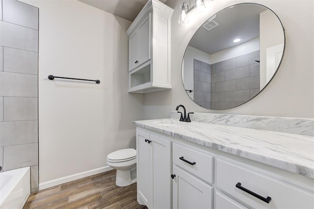 full bathroom featuring hardwood / wood-style flooring, vanity, shower / bathtub combination, and toilet