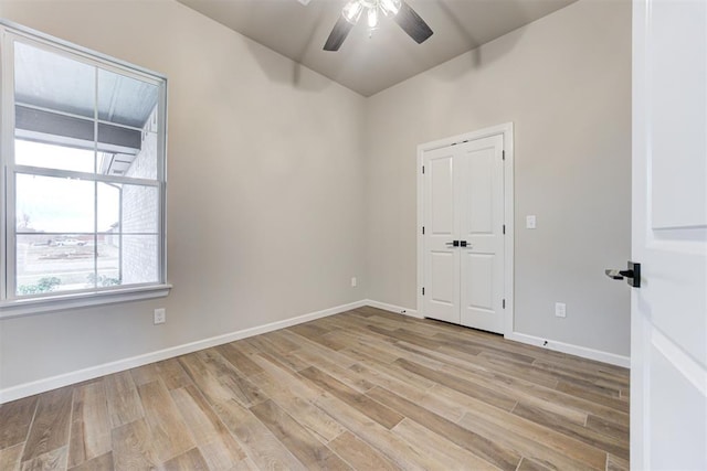 empty room with ceiling fan and light wood-type flooring