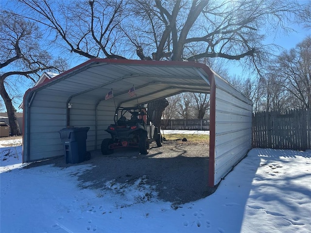 snow covered parking with a carport