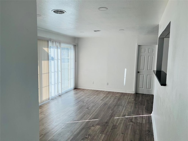 spare room featuring dark hardwood / wood-style flooring