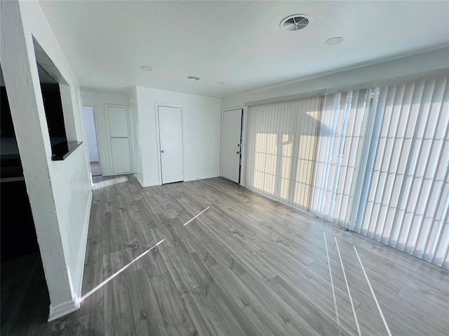 unfurnished living room featuring hardwood / wood-style floors