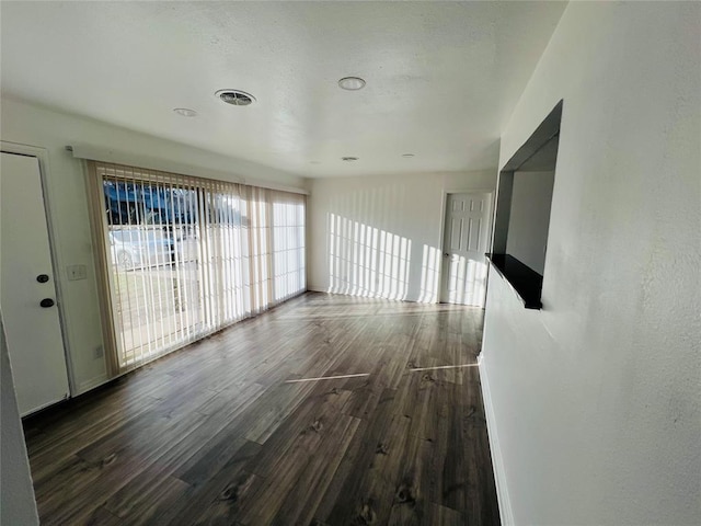 unfurnished room with dark hardwood / wood-style floors