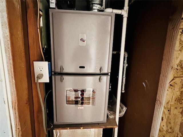 utility room featuring heating unit