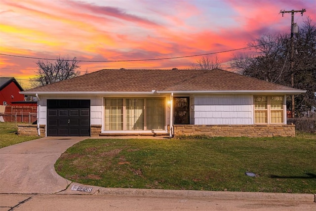 ranch-style house with stone siding, a lawn, concrete driveway, and a shingled roof