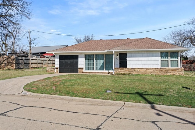 single story home with a front lawn, driveway, stone siding, fence, and roof with shingles