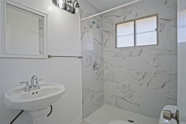 full bath with a shower stall, toilet, and a sink