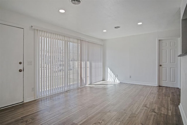 interior space with visible vents, recessed lighting, baseboards, and wood finished floors