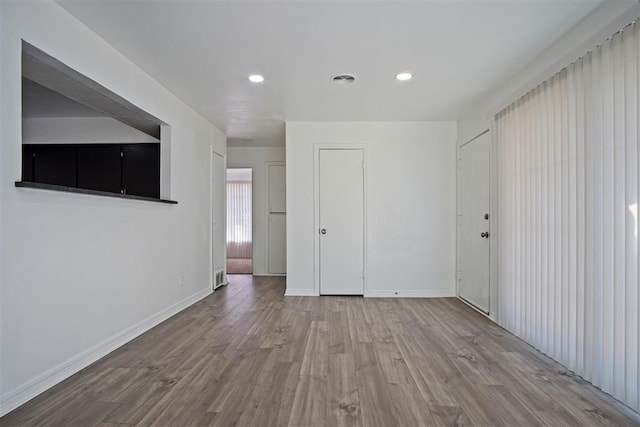 interior space with recessed lighting, baseboards, and wood finished floors