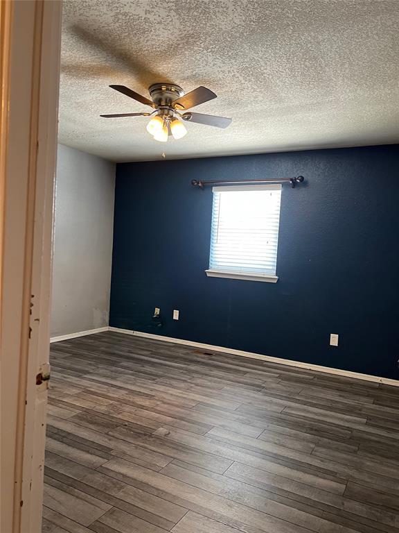 spare room featuring ceiling fan and wood-type flooring