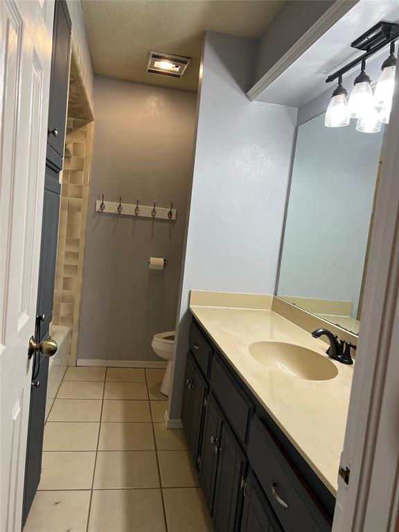 bathroom with tile patterned floors, vanity, and toilet