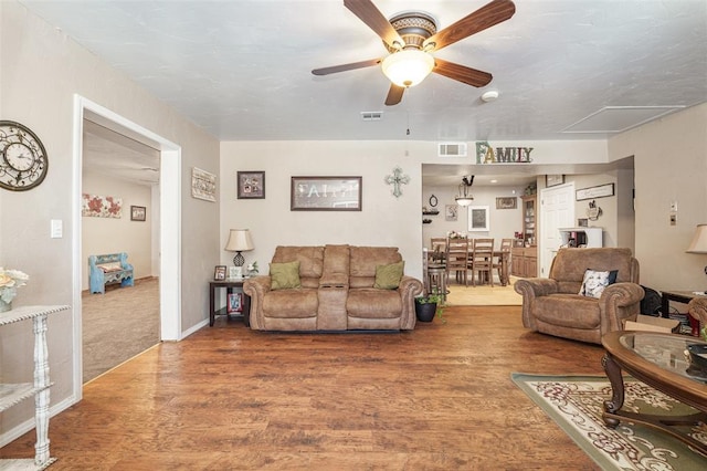 living room with ceiling fan and wood-type flooring