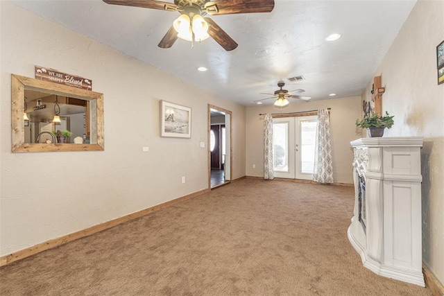 unfurnished living room with french doors, light colored carpet, and ceiling fan