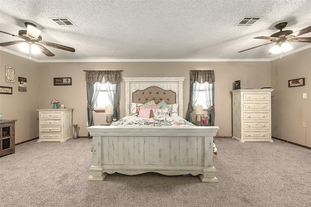 carpeted bedroom with a textured ceiling, ceiling fan, and ornamental molding