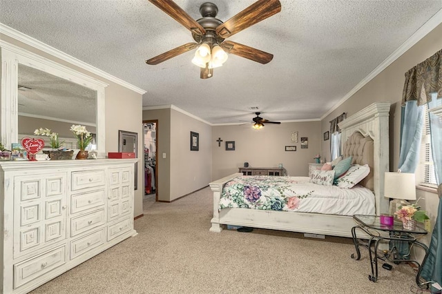 carpeted bedroom with a textured ceiling, ceiling fan, and ornamental molding