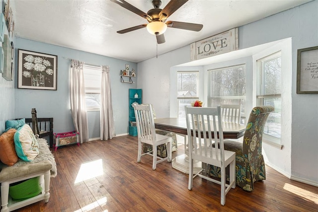 dining space featuring plenty of natural light, dark wood-type flooring, and ceiling fan