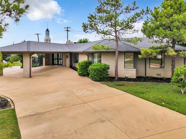 ranch-style home with a carport and a front yard