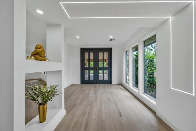 foyer featuring french doors and light wood-type flooring