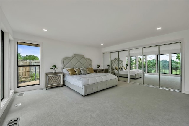 carpeted bedroom featuring multiple windows