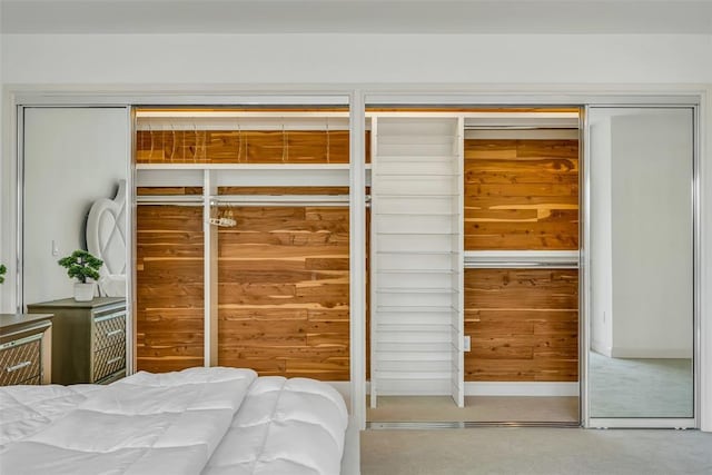 bedroom featuring carpet floors and wooden walls