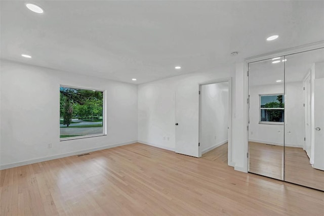 empty room with light hardwood / wood-style flooring