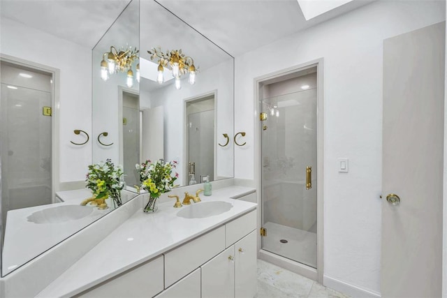 bathroom with tile patterned floors, vanity, a shower with door, and a skylight