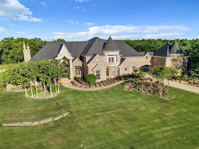 french country home featuring a front yard