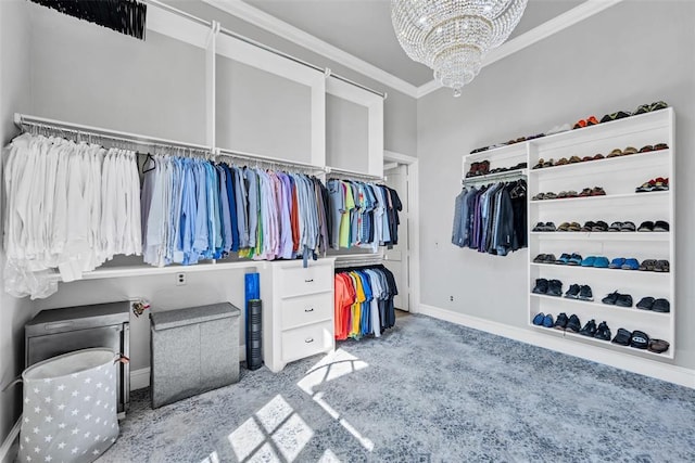 walk in closet with carpet flooring and an inviting chandelier