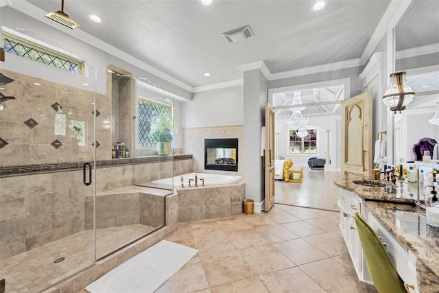 bathroom featuring vanity, plus walk in shower, tile patterned floors, a multi sided fireplace, and crown molding