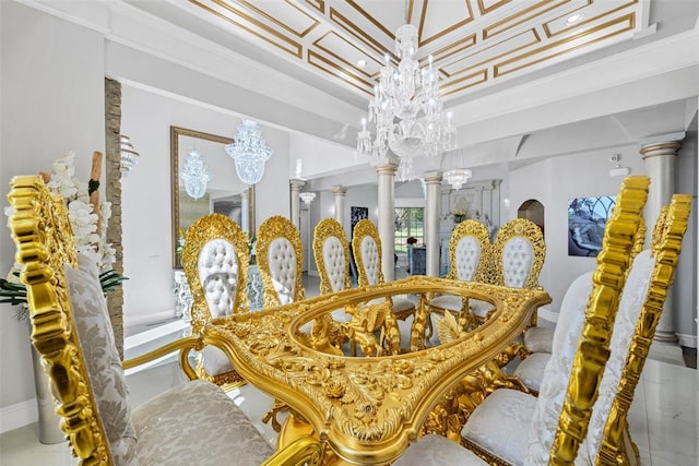 dining room featuring ornate columns, a chandelier, and ornamental molding