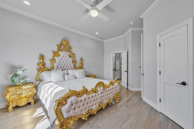 bedroom featuring light wood-type flooring, ensuite bath, ceiling fan, and crown molding