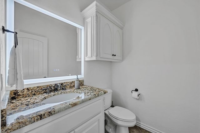 bathroom featuring vanity and toilet