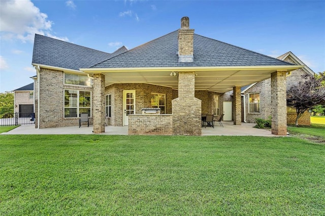 rear view of property featuring a yard, a patio, and area for grilling