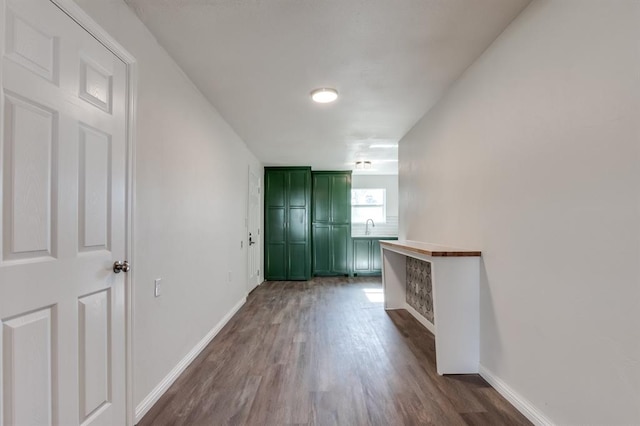 corridor with dark hardwood / wood-style flooring