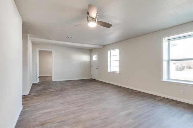 empty room with wood-type flooring and ceiling fan