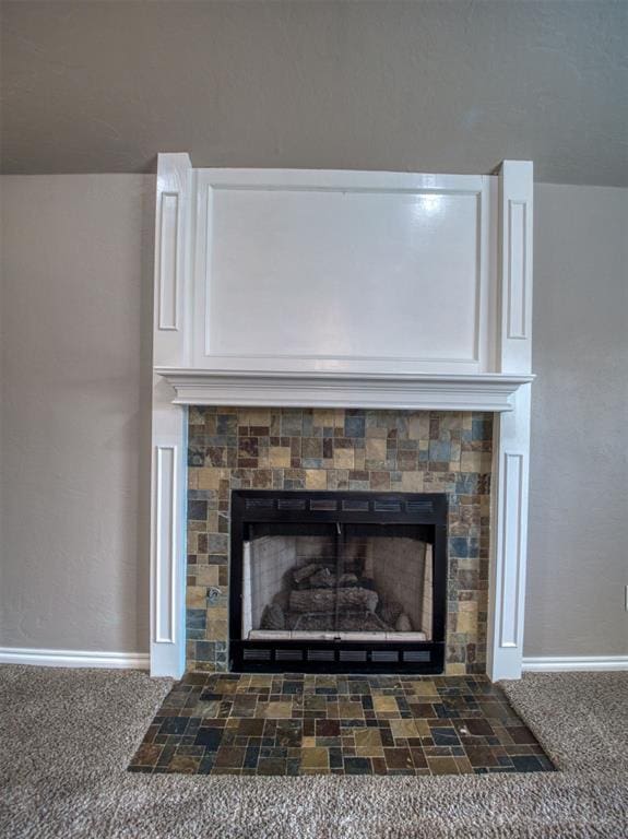 interior details featuring a fireplace and carpet