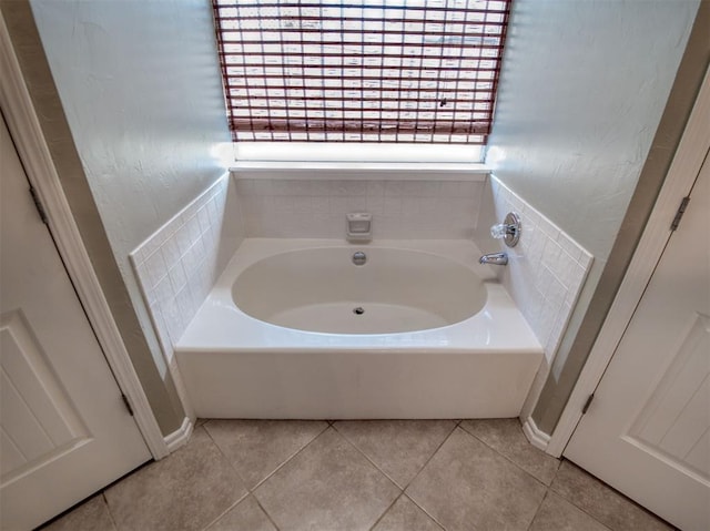 bathroom featuring tile patterned flooring and a tub