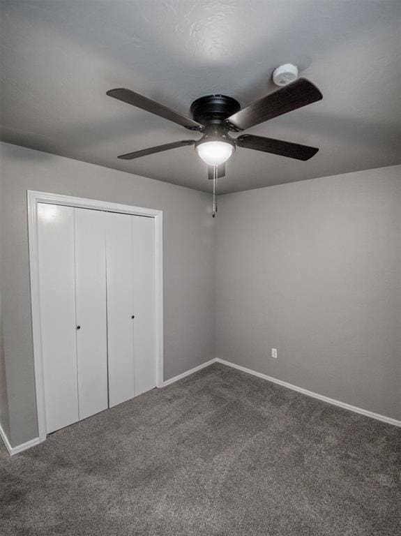 unfurnished bedroom featuring ceiling fan, a closet, and carpet floors