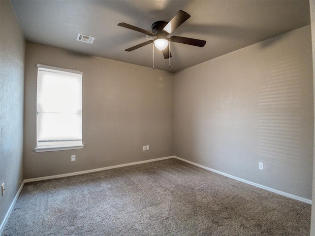 carpeted spare room featuring ceiling fan