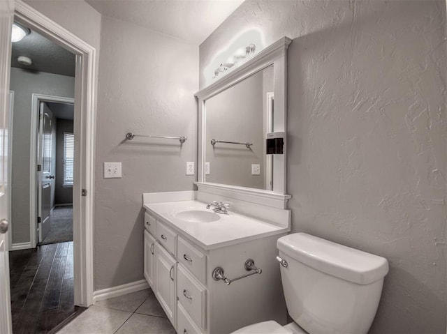 bathroom featuring toilet, vanity, and tile patterned floors